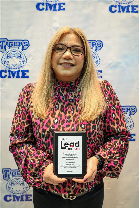 Stephanie Viado holding the Impact Award plaque